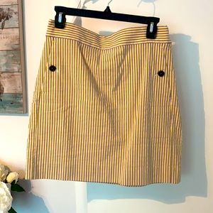 White, yellow,pink, and green striped skirt.